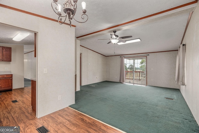 unfurnished living room with wood finished floors, visible vents, a textured ceiling, and ceiling fan with notable chandelier
