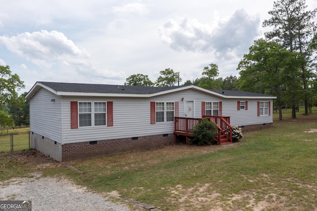 manufactured / mobile home with fence, a front yard, and crawl space