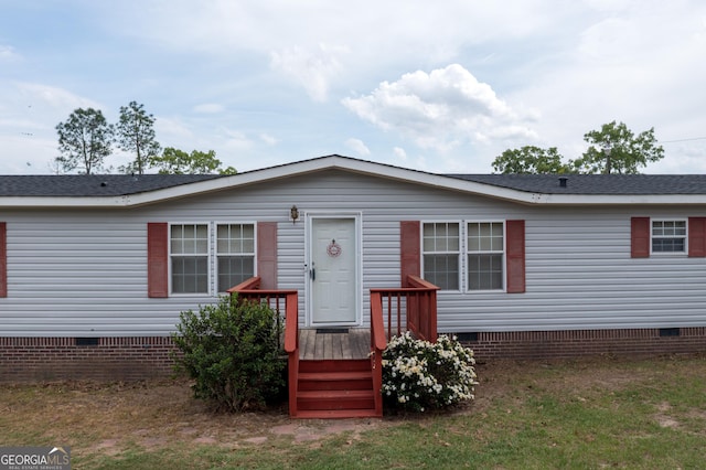 manufactured / mobile home with a wooden deck and crawl space