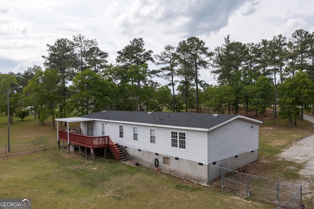 rear view of property featuring a lawn, a deck, fence, and crawl space