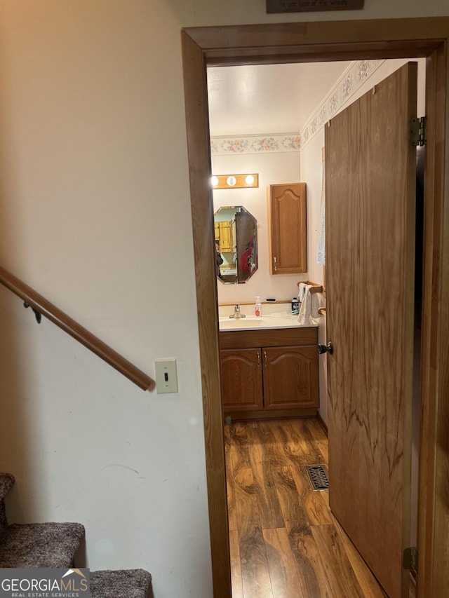 bathroom featuring vanity, visible vents, and wood finished floors