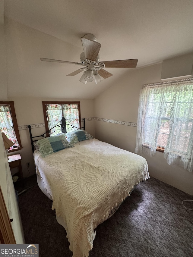 carpeted bedroom with lofted ceiling and a ceiling fan