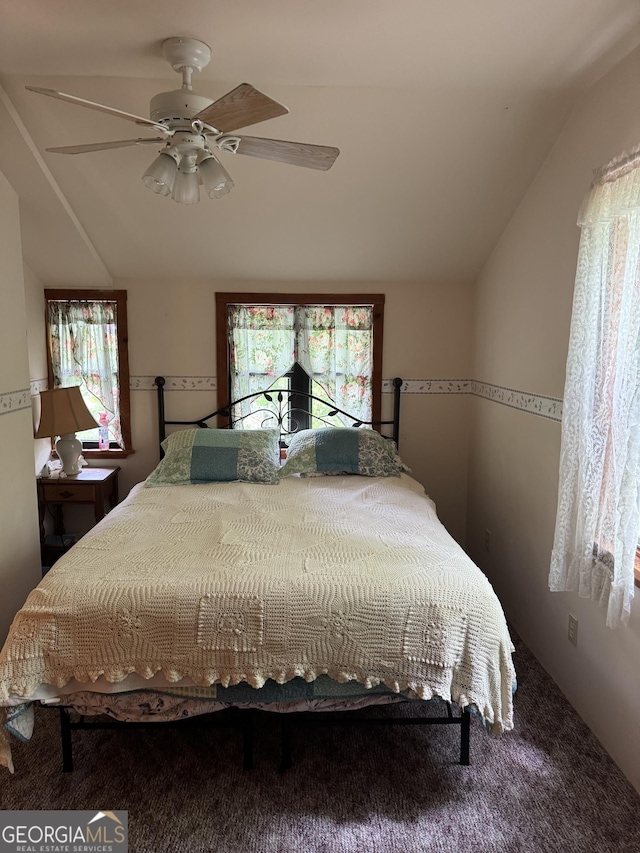 bedroom featuring ceiling fan, lofted ceiling, and carpet flooring