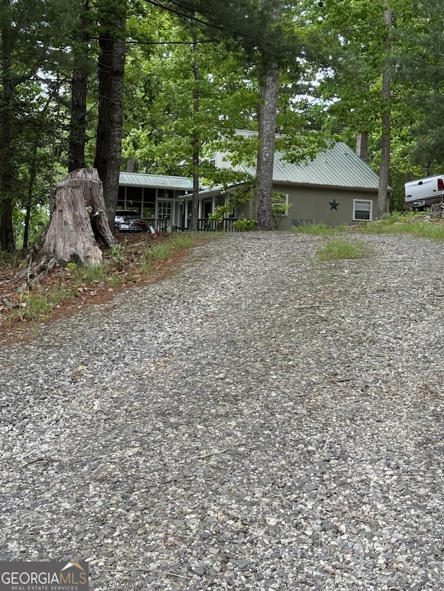 view of yard with gravel driveway