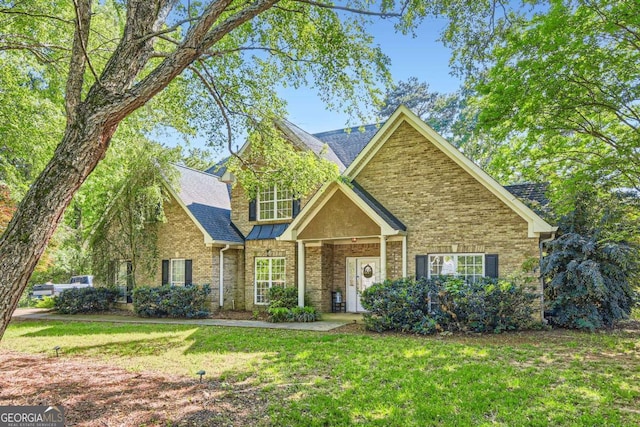 595 Mcgarity Dr, Mcdonough, GA 30252 - view of front of home with a shingled roof, brick siding, and a front yard