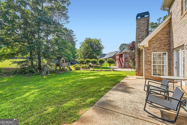 595 Mcgarity Dr, Mcdonough, GA 30252 - view of yard featuring a playground and a patio