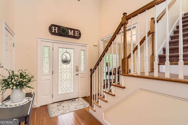 595 Mcgarity Dr, Mcdonough, GA 30252 - entrance foyer with stairway, wood-type flooring, and a towering ceiling