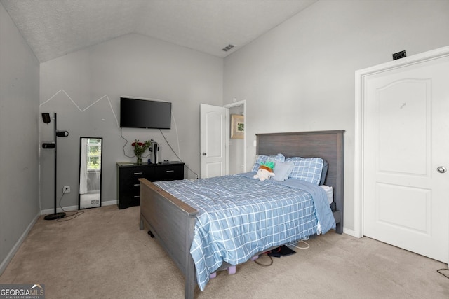 bedroom featuring light carpet, baseboards, visible vents, and high vaulted ceiling