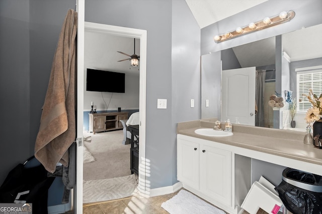 full bathroom with ensuite bathroom, tile patterned flooring, ceiling fan, vaulted ceiling, and vanity