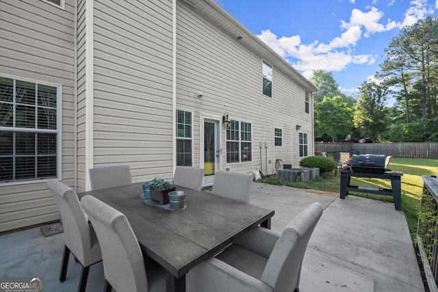 view of patio with outdoor dining area and fence