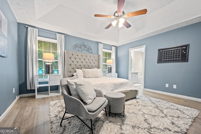 173 Kingswood Dr, Ellenwood, GA 30294 - bedroom featuring a raised ceiling, multiple windows, and wood finished floors
