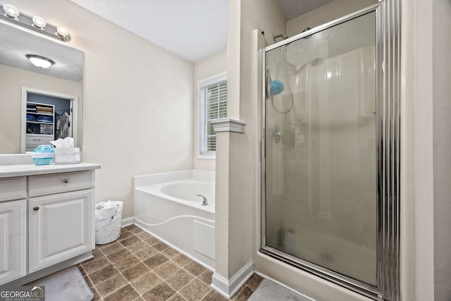 173 Kingswood Dr, Ellenwood, GA 30294 - bathroom featuring a shower stall, baseboards, vanity, and a bath
