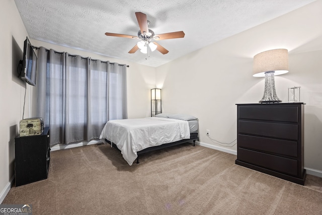 173 Kingswood Dr, Ellenwood, GA 30294 - carpeted bedroom featuring a textured ceiling, baseboards, and a ceiling fan