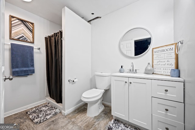 173 Kingswood Dr, Ellenwood, GA 30294 - full bath with curtained shower, toilet, baseboards, and vanity