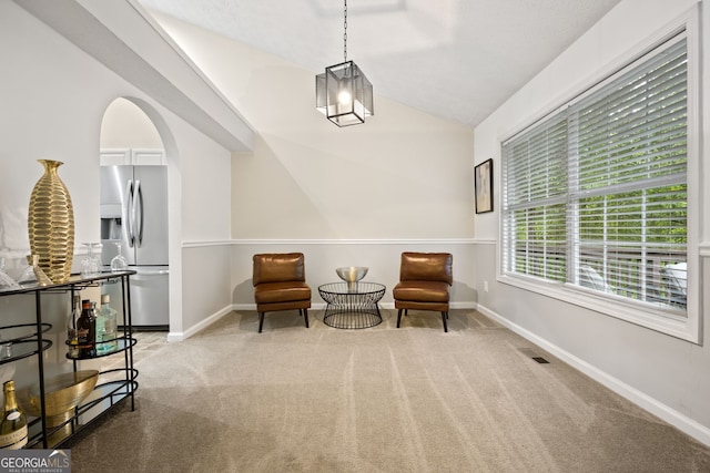 173 Kingswood Dr, Ellenwood, GA 30294 - sitting room featuring lofted ceiling, carpet, visible vents, arched walkways, and baseboards