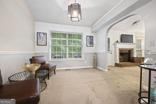 173 Kingswood Dr, Ellenwood, GA 30294 - living area featuring carpet, visible vents, a healthy amount of sunlight, and arched walkways