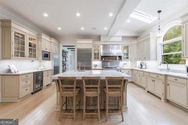 4500 Candacraig, Alpharetta, GA 30022 - kitchen featuring wine cooler, built in appliances, exhaust hood, a sink, and backsplash
