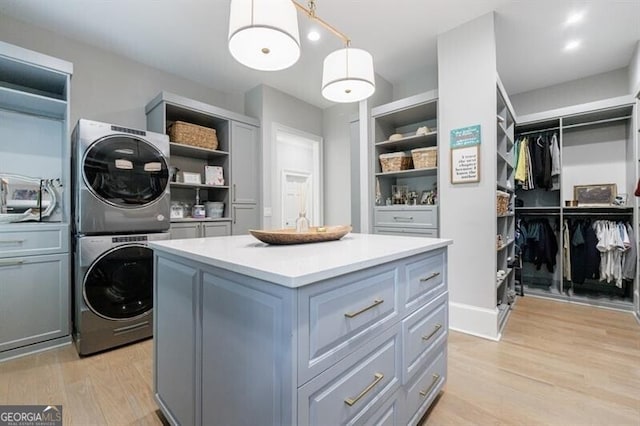 4500 Candacraig, Alpharetta, GA 30022 - walk in closet featuring stacked washer and clothes dryer and light wood-style flooring