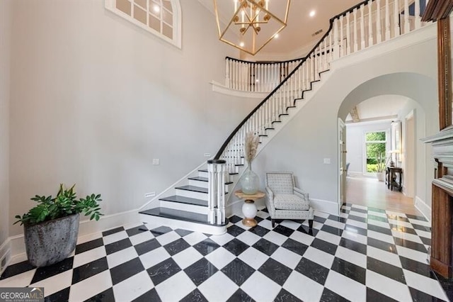 4500 Candacraig, Alpharetta, GA 30022 - interior space with an inviting chandelier, tile patterned floors, stairway, baseboards, and arched walkways
