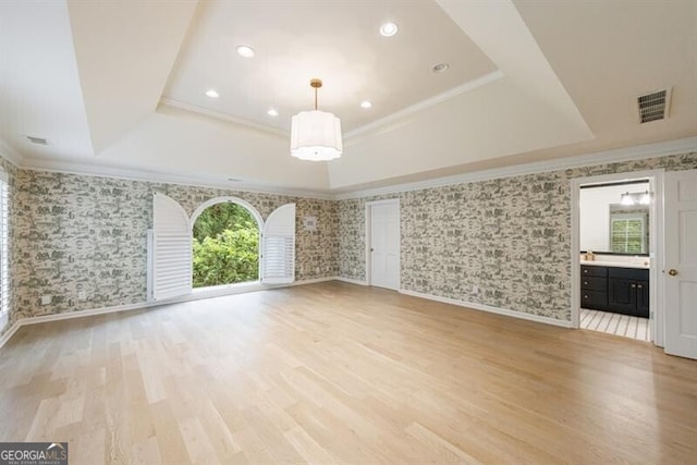 4500 Candacraig, Alpharetta, GA 30022 - unfurnished living room with a tray ceiling, wallpapered walls, crown molding, light wood-type flooring, and visible vents