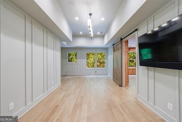 4500 Candacraig, Alpharetta, GA 30022 - unfurnished living room featuring light wood-type flooring, recessed lighting, a barn door, and wooden ceiling