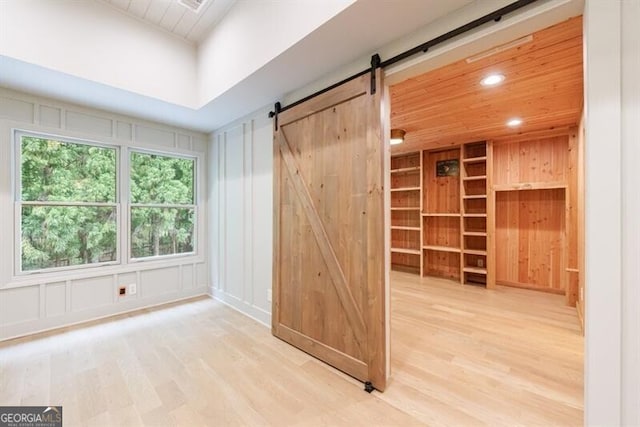 4500 Candacraig, Alpharetta, GA 30022 - interior space featuring a decorative wall, a barn door, and wood finished floors