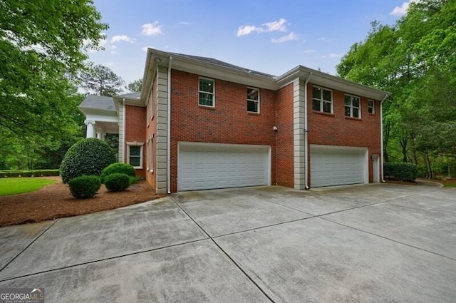 4500 Candacraig, Alpharetta, GA 30022 - view of home's exterior with a garage, brick siding, and driveway