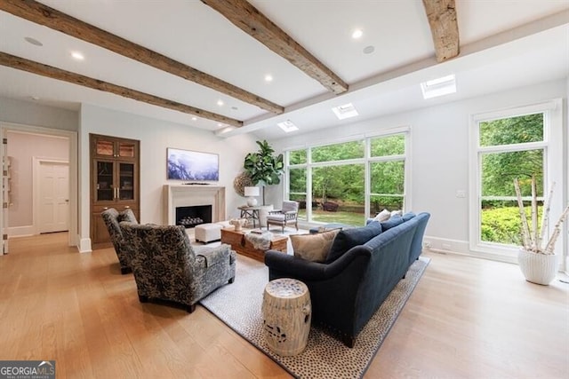 4500 Candacraig, Alpharetta, GA 30022 - living area featuring a fireplace, beamed ceiling, light wood-type flooring, and baseboards