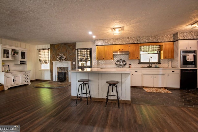 588 Pinetree Rd, Blue Ridge, GA 30513 - kitchen with light countertops, a textured ceiling, dark wood-style flooring, dishwasher, and stainless steel oven