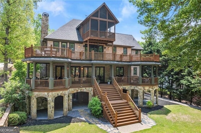 4290 Bobbins Way, Cumming, GA 30041 - rear view of property with stone siding, a balcony, stairway, a chimney, and a lawn