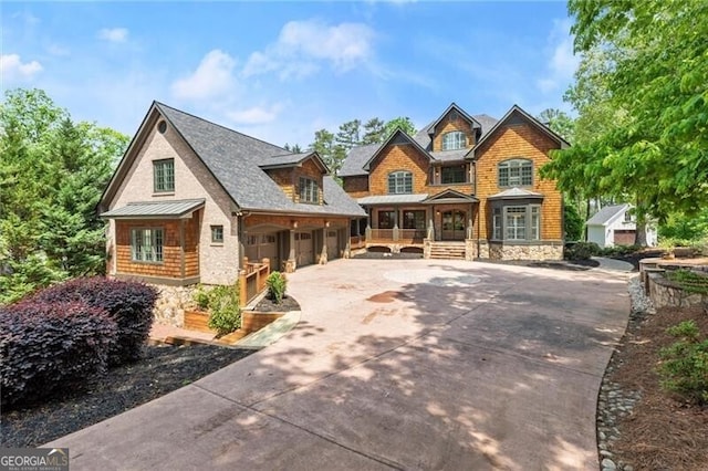 4290 Bobbins Way, Cumming, GA 30041 - view of front facade with concrete driveway, stone siding, covered porch, and a garage