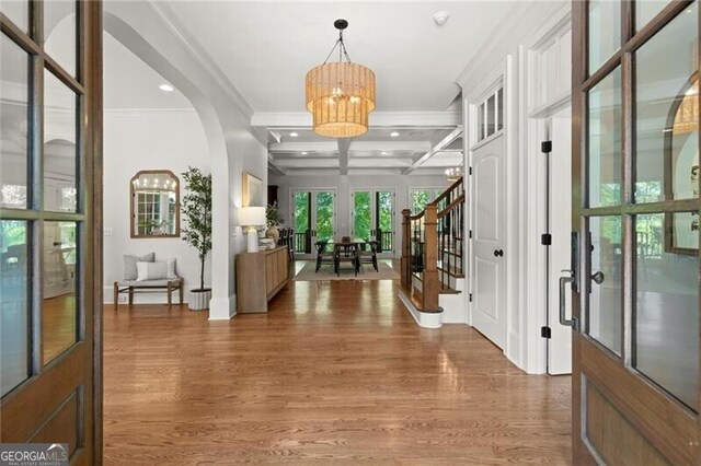 4290 Bobbins Way, Cumming, GA 30041 - foyer entrance with coffered ceiling, a chandelier, ornamental molding, light wood-type flooring, and stairway