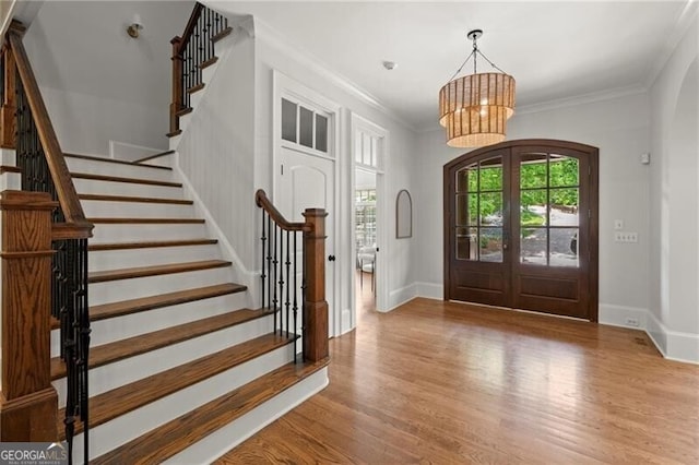 4290 Bobbins Way, Cumming, GA 30041 - entrance foyer featuring stairway, a chandelier, wood finished floors, baseboards, and crown molding