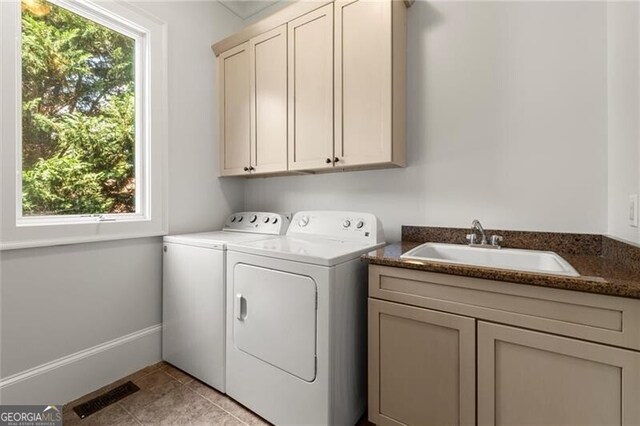 4290 Bobbins Way, Cumming, GA 30041 - laundry area with cabinet space, washing machine and dryer, and light tile patterned flooring