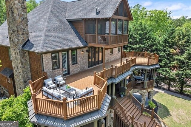 4290 Bobbins Way, Cumming, GA 30041 - back of house with roof with shingles, a chimney, a sunroom, and a wooden deck