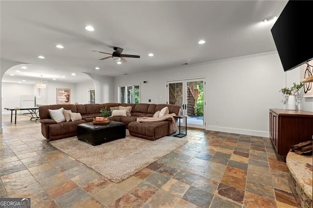 4290 Bobbins Way, Cumming, GA 30041 - living room featuring stone tile floors, arched walkways, recessed lighting, a ceiling fan, and ornamental molding