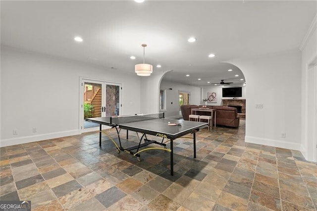 4290 Bobbins Way, Cumming, GA 30041 - playroom featuring stone tile floors, arched walkways, recessed lighting, baseboards, and a ceiling fan