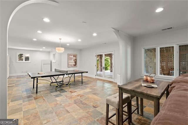 4290 Bobbins Way, Cumming, GA 30041 - rec room with arched walkways, recessed lighting, stone tile flooring, plenty of natural light, and baseboards