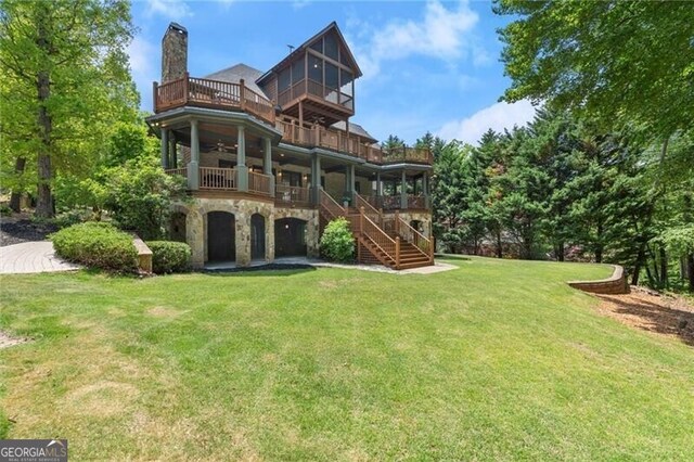 4290 Bobbins Way, Cumming, GA 30041 - rear view of property featuring a balcony, stone siding, a yard, a chimney, and stairs