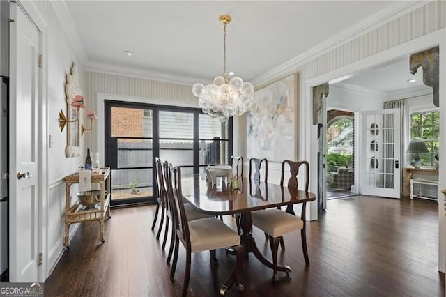 820 Wilson Rd NW, Atlanta, GA 30318 - dining space featuring an inviting chandelier, crown molding, wallpapered walls, and dark wood-type flooring