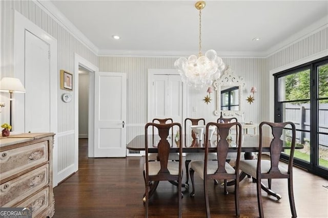 820 Wilson Rd NW, Atlanta, GA 30318 - dining area with a notable chandelier, ornamental molding, wallpapered walls, and dark wood-style flooring