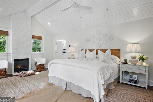 820 Wilson Rd NW, Atlanta, GA 30318 - bedroom featuring a ceiling fan, multiple windows, a fireplace, and vaulted ceiling with beams