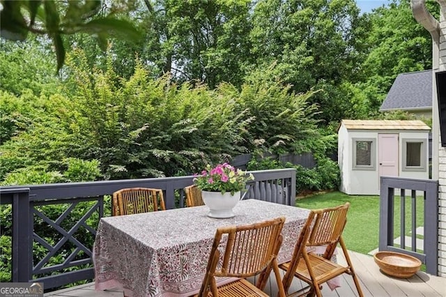 820 Wilson Rd NW, Atlanta, GA 30318 - wooden terrace with outdoor dining area, an outdoor structure, and a storage unit