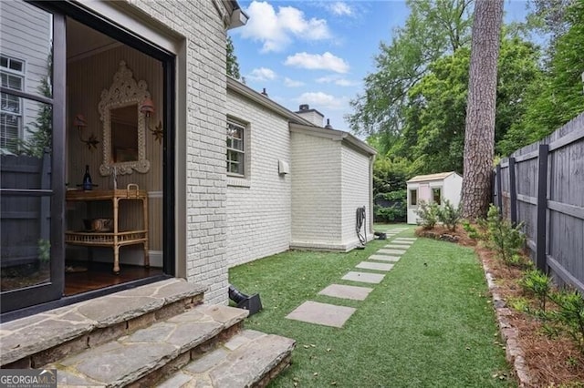820 Wilson Rd NW, Atlanta, GA 30318 - view of yard featuring a shed, fence, and an outbuilding