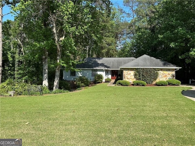 single story home featuring a front lawn and stone siding