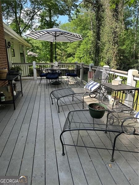 wooden terrace featuring outdoor dining space