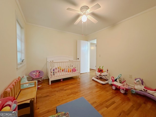 861 Ga Highway 87 N, Cochran, GA 31014 - bedroom featuring ornamental molding, a ceiling fan, a crib, and wood finished floors