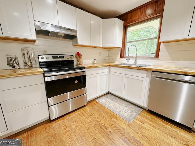 861 Ga Highway 87 N, Cochran, GA 31014 - kitchen with wooden counters, a sink, appliances with stainless steel finishes, and under cabinet range hood