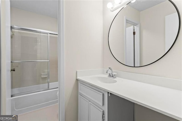 bathroom with vanity and shower / bath combination with glass door