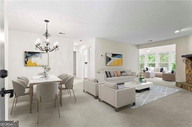 living area with a chandelier and light carpet